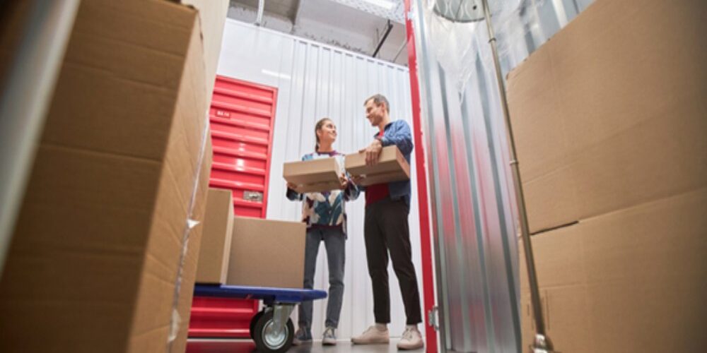 Couple renting a self storage unit at a secure facility