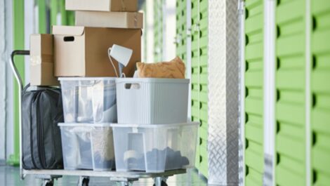 Dolly cart loaded with moving boxes being transported at a storage facility